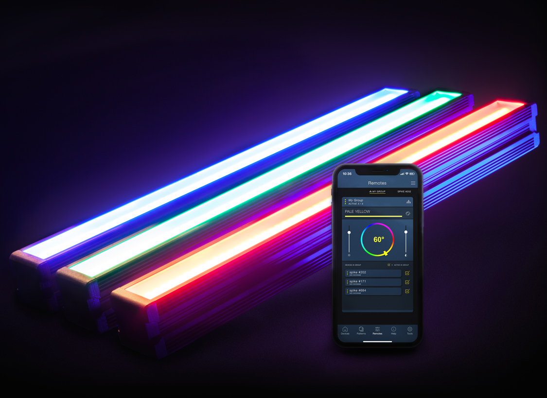 Three Colorspike lights glowing blue, green, and red beside their mobile control app